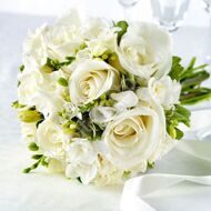 Wedding bridal bouquet of white roses and freesias